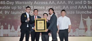 Six professionals in suits on a stage presenting a framed award plaque.