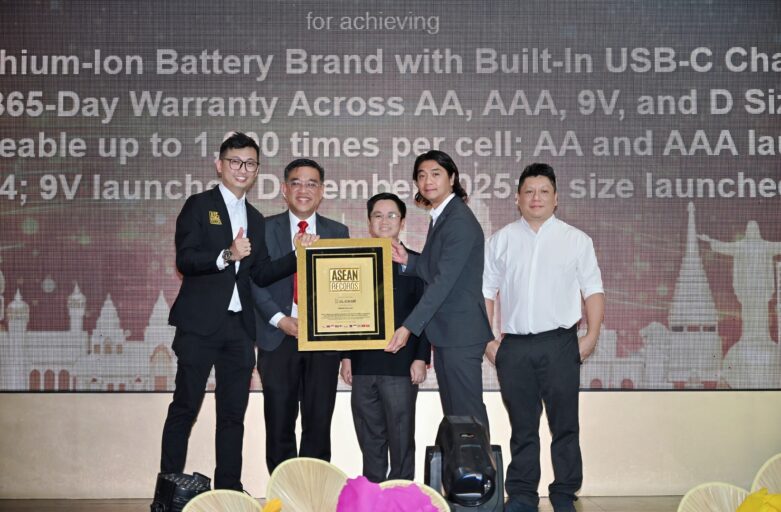 Six professionals in suits on a stage presenting a framed award plaque.