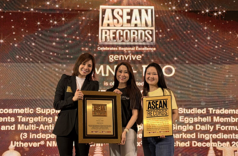 Three women stand on a stage holding ASEAN Records plaques, smiling at the camera with a branded backdrop behind them.