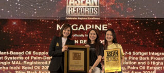 Three smiling women pose with ASEAN Records plaques on stage at an awards ceremony.