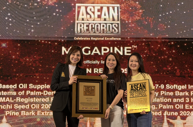 Three smiling women pose with ASEAN Records plaques on stage at an awards ceremony.