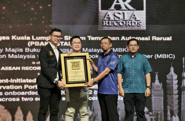 Four men on stage hold a framed award plaque as others look on, with an ASEAN Records backdrop behind them.