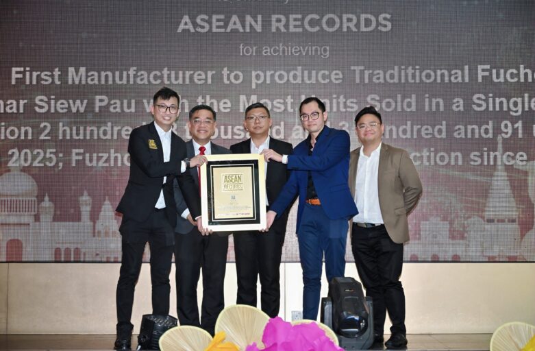 Five men in suits pose on a stage, holding a framed award with a large ASEAN RECORDS backdrop behind them.