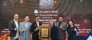 Group of six professionals on stage posing with a framed award against a backdrop that reads ASEAN Records and Alliance Bank.",