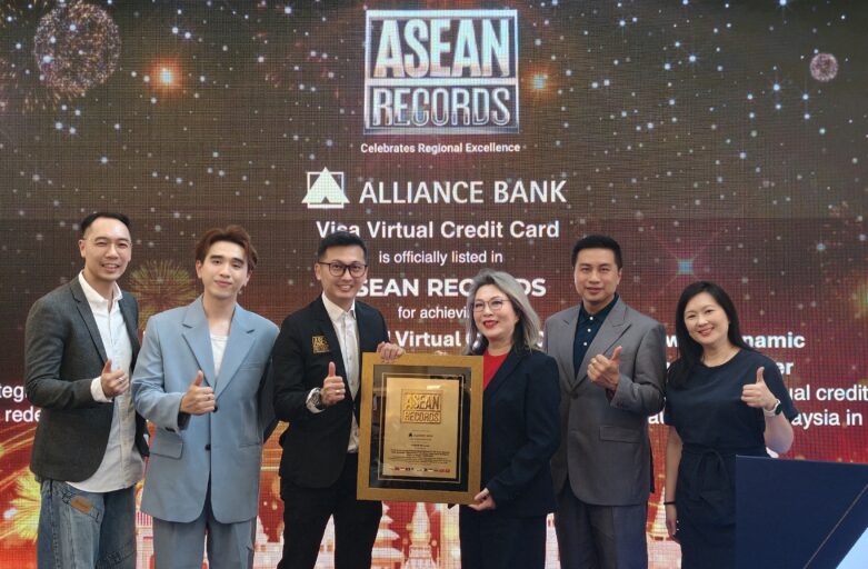 Group of six professionals on stage posing with a framed award against a backdrop that reads ASEAN Records and Alliance Bank.",
