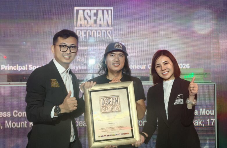 Three people on stage pose with a large framed ASEAN Records certificate, smiling in front of a colorful backdrop.